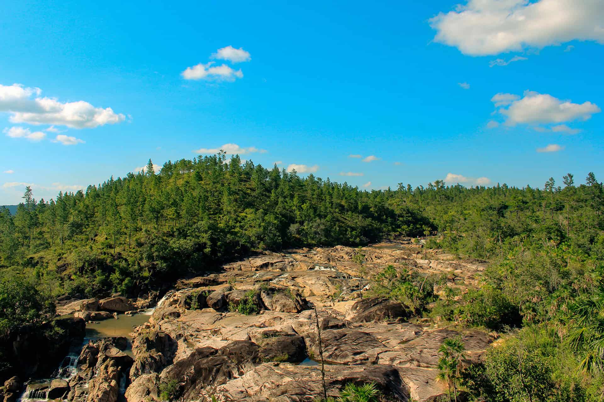 Scenic hiking trail with rocky terrain and lush greenery in Belize.