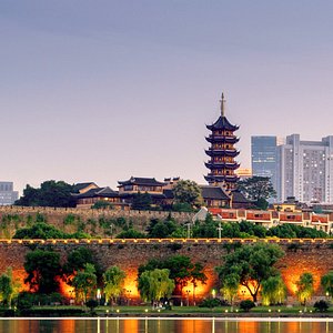 Ancient Maya ruins with a traditional pagoda in the background, showcasing Belize's rich cultural he.